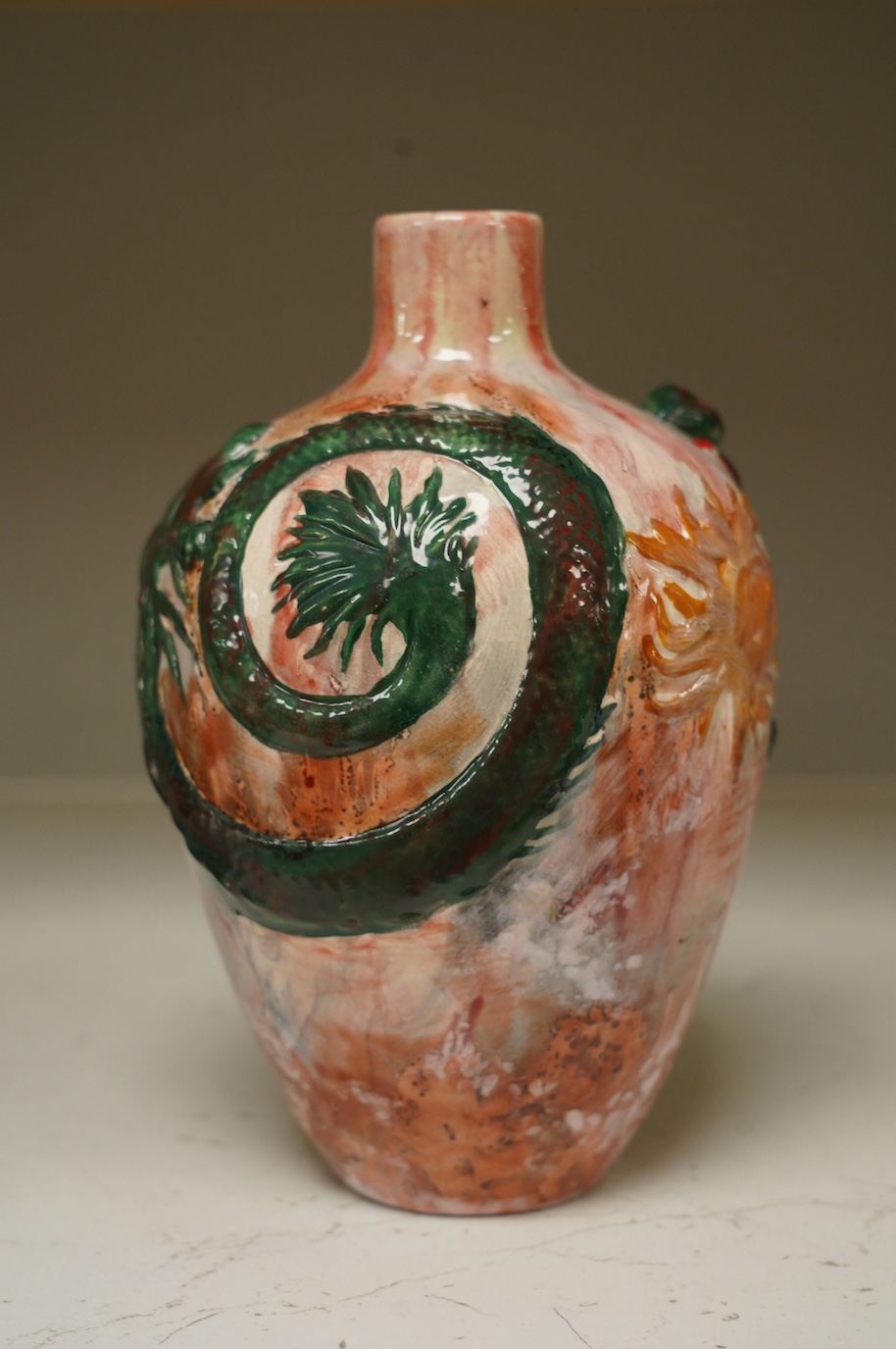 A Bretby impasto vase with raised dragon's head and body, flambé style glaze, impressed Bretby 2761?, 20cm high. Condition - good